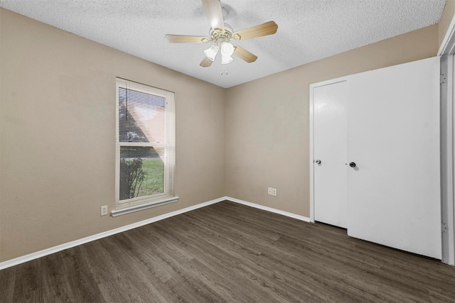 unfurnished room featuring ceiling fan, a textured ceiling, and dark hardwood / wood-style flooring