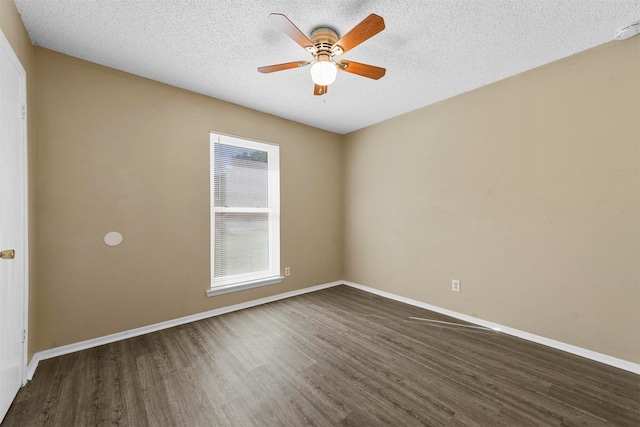 unfurnished room with ceiling fan, a textured ceiling, and dark wood-type flooring