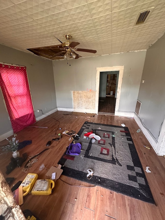 unfurnished living room with wood-type flooring and ceiling fan