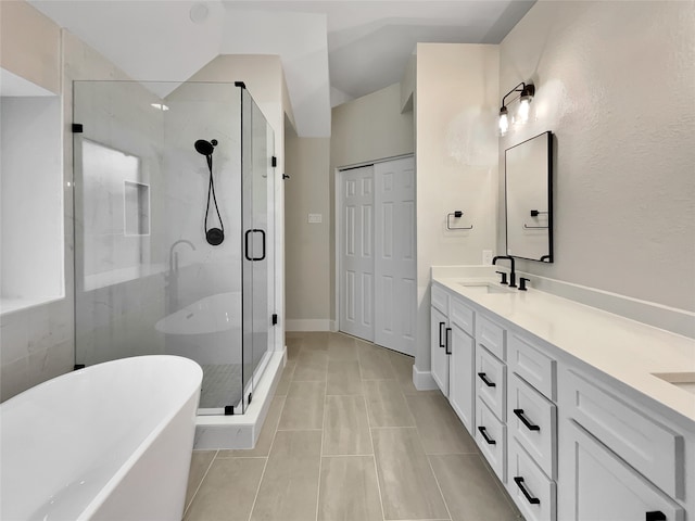 bathroom featuring plus walk in shower, tile patterned floors, and vanity