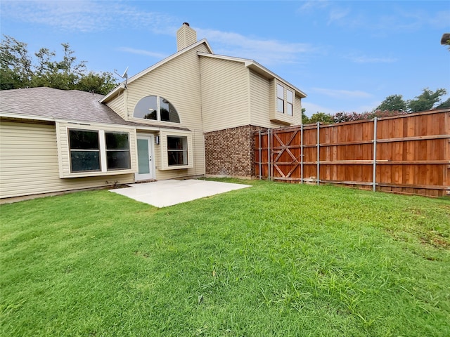 back of property featuring a patio and a yard