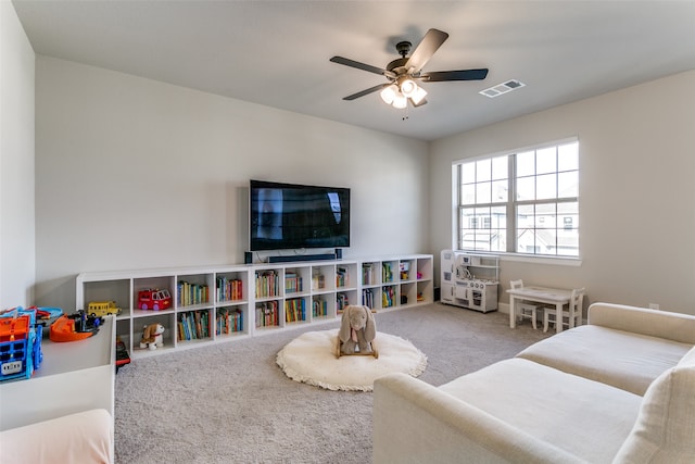 rec room featuring a ceiling fan, carpet, and visible vents