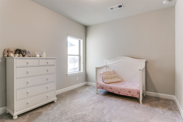 sitting room with visible vents, light colored carpet, and baseboards