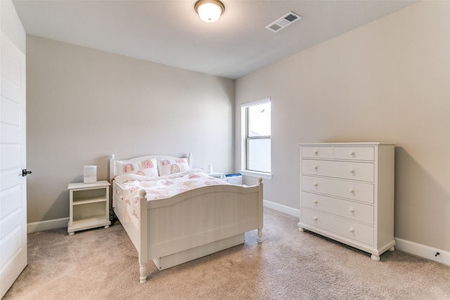 bedroom with visible vents, light colored carpet, and baseboards