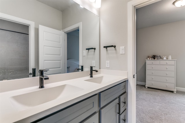 bathroom with double vanity, baseboards, and a sink