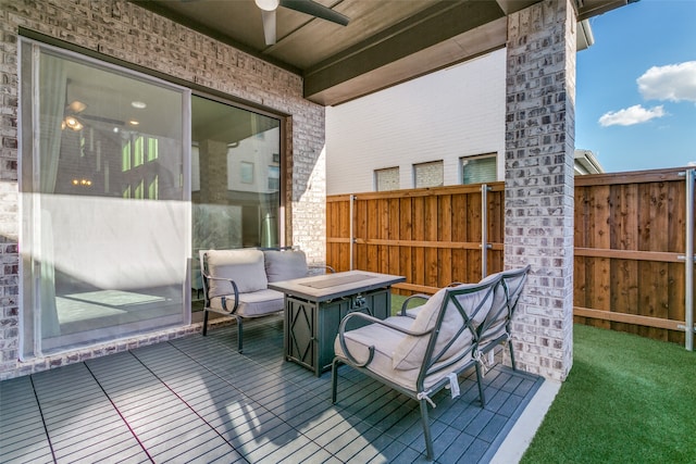 wooden terrace featuring a ceiling fan and fence