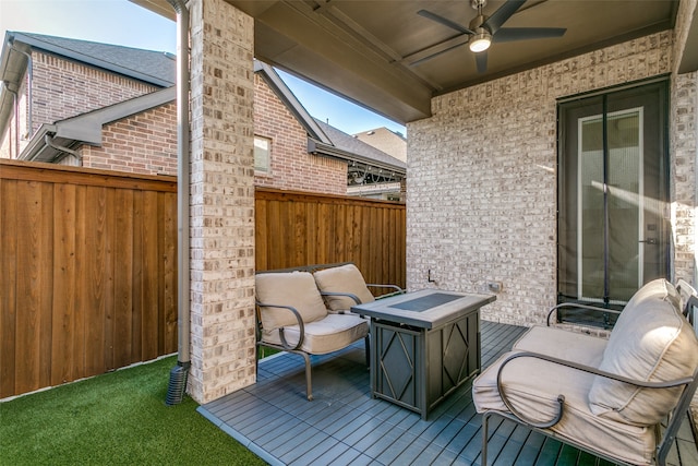 wooden deck featuring a ceiling fan and fence