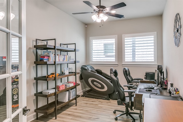 office area with baseboards, wood finished floors, and a ceiling fan