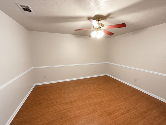 spare room featuring ceiling fan, a textured ceiling, and wood-type flooring