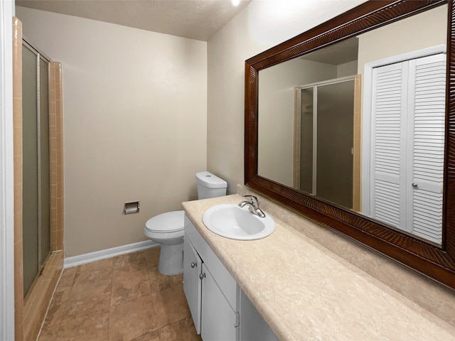 bathroom with walk in shower, vanity, and toilet