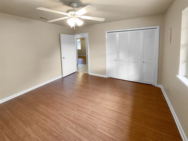 unfurnished bedroom with a closet, ceiling fan, and hardwood / wood-style flooring