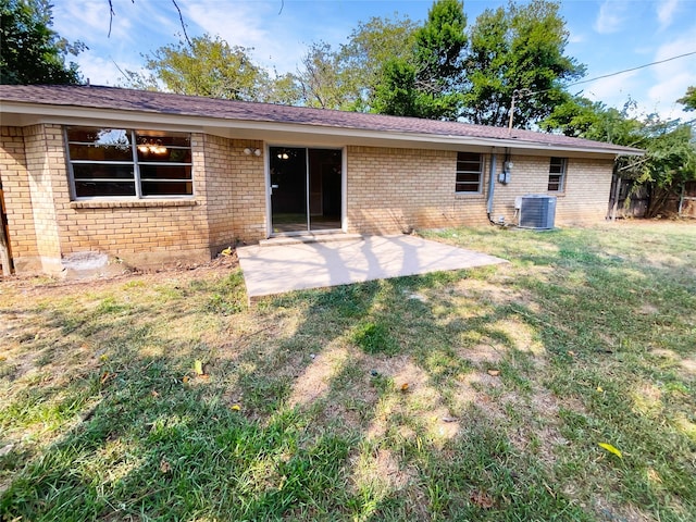 back of property featuring a yard, central AC unit, and a patio area