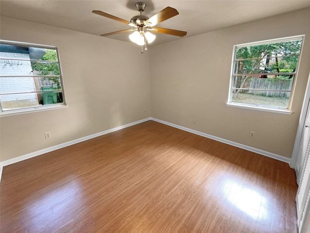 empty room with ceiling fan and wood-type flooring