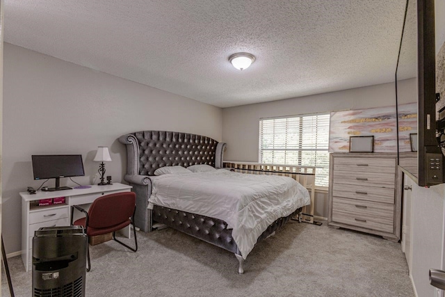 bedroom featuring a textured ceiling and light colored carpet