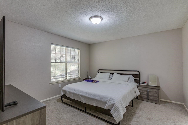 carpeted bedroom featuring a textured ceiling