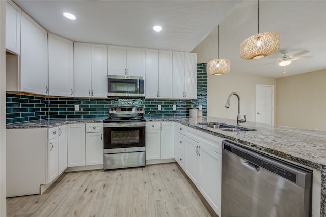 kitchen with white cabinets, stainless steel appliances, and sink