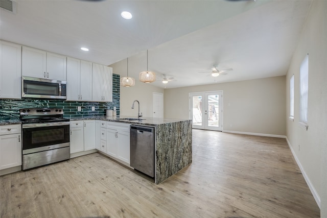 kitchen with white cabinetry, sink, french doors, pendant lighting, and appliances with stainless steel finishes