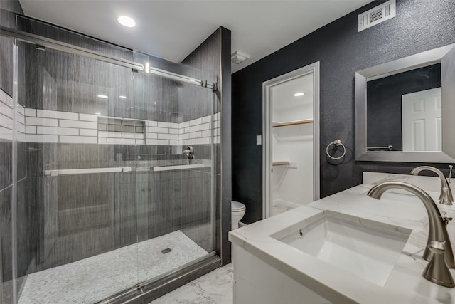 bathroom featuring vanity, toilet, and walk in shower