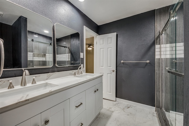 bathroom featuring vanity and a shower with door