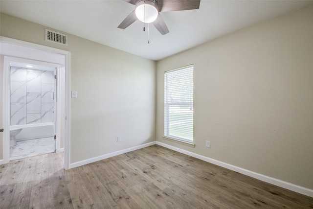 unfurnished room featuring ceiling fan and light wood-type flooring