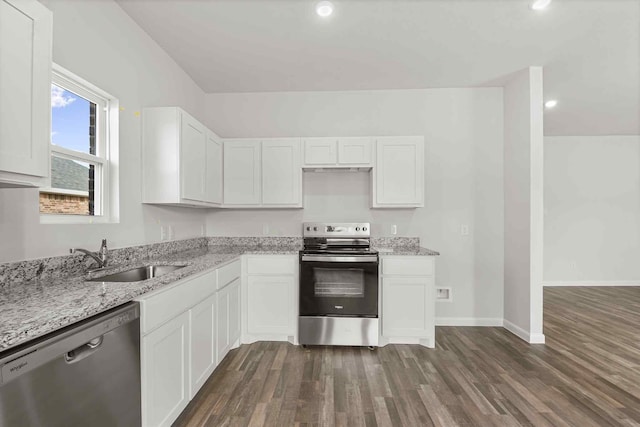 kitchen featuring sink, dark wood-type flooring, appliances with stainless steel finishes, white cabinetry, and light stone counters