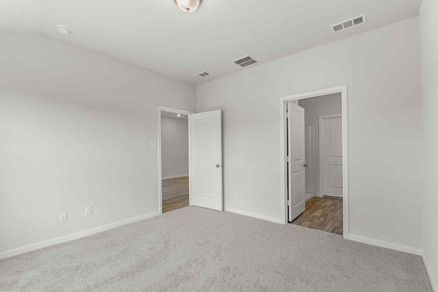 unfurnished bedroom featuring dark carpet