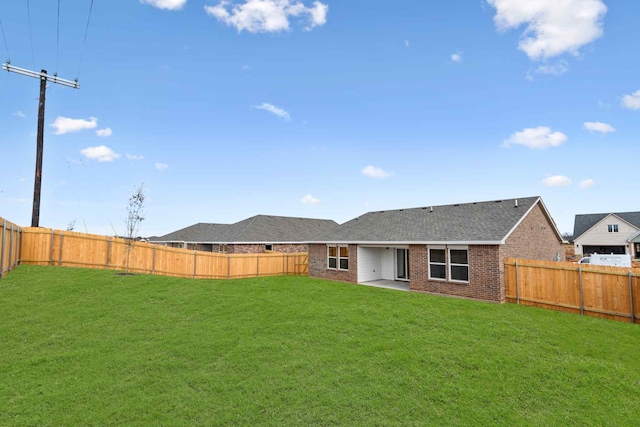 back of property featuring a yard and a patio area