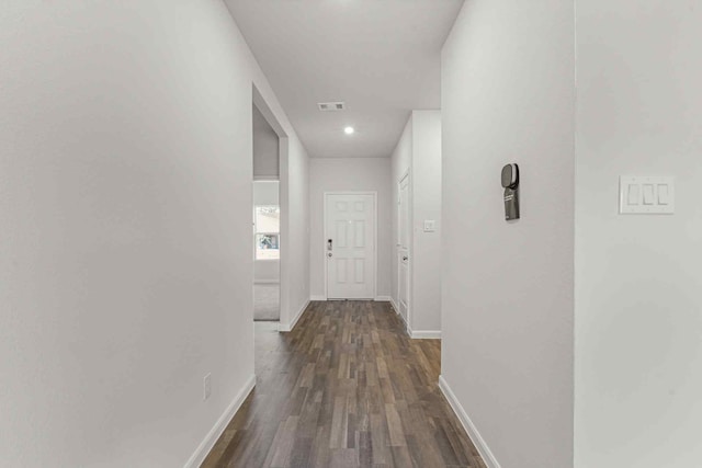 hallway with dark wood-type flooring