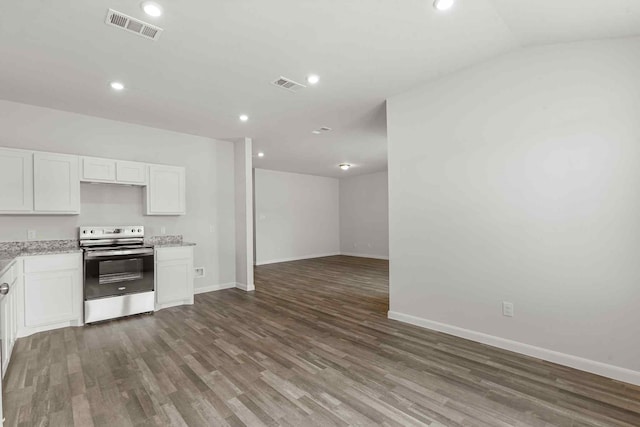 kitchen featuring dark wood-type flooring, white cabinets, and electric range