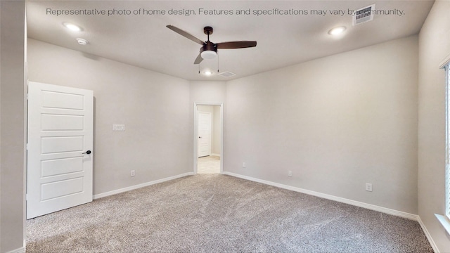 carpeted spare room with ceiling fan