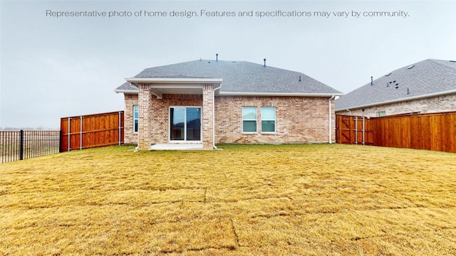 rear view of property with a yard and a patio