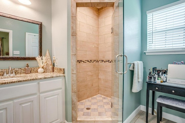 bathroom with tile patterned flooring, a shower with door, and vanity