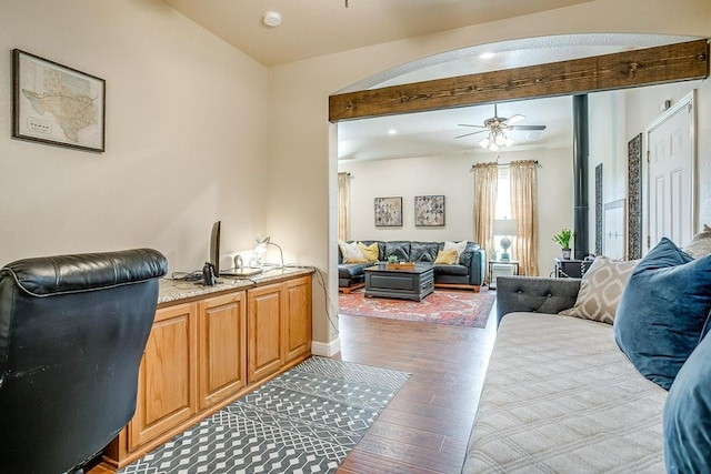 office area featuring ceiling fan, beamed ceiling, and hardwood / wood-style flooring