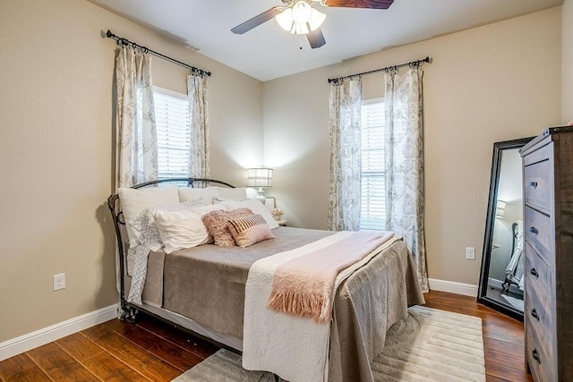 bedroom with multiple windows, ceiling fan, and dark hardwood / wood-style floors