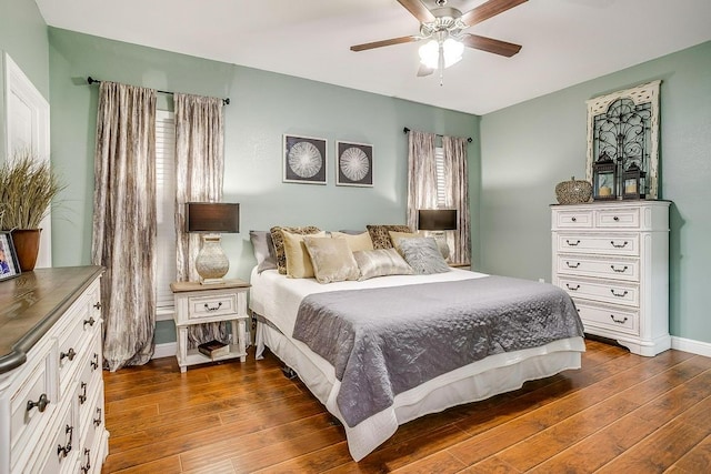 bedroom with ceiling fan and dark wood-type flooring