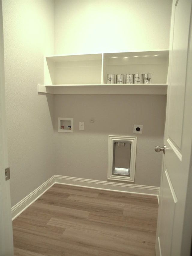 clothes washing area with gas dryer hookup, hardwood / wood-style floors, electric dryer hookup, and hookup for a washing machine