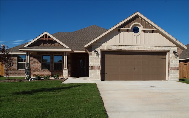 craftsman house featuring a garage and a front lawn