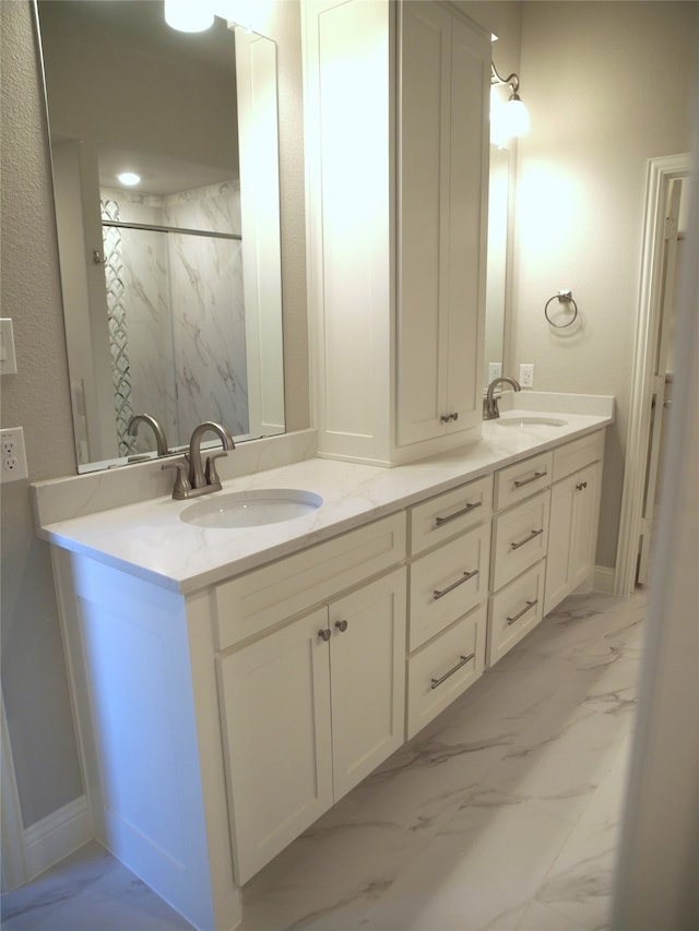 bathroom featuring vanity and tiled shower