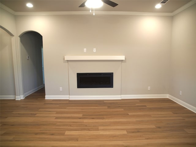 unfurnished living room with ornamental molding, ceiling fan, and hardwood / wood-style flooring