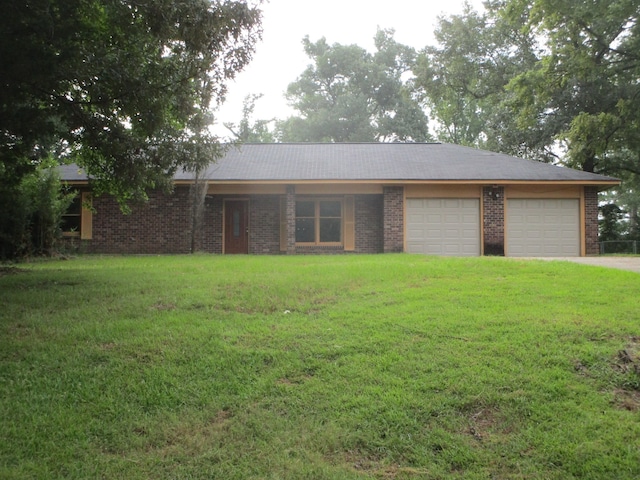 ranch-style home featuring a garage and a front lawn