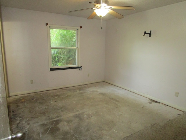 empty room with concrete flooring and ceiling fan