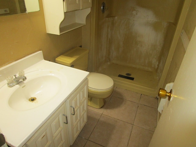 bathroom featuring walk in shower, tile patterned flooring, vanity, and toilet