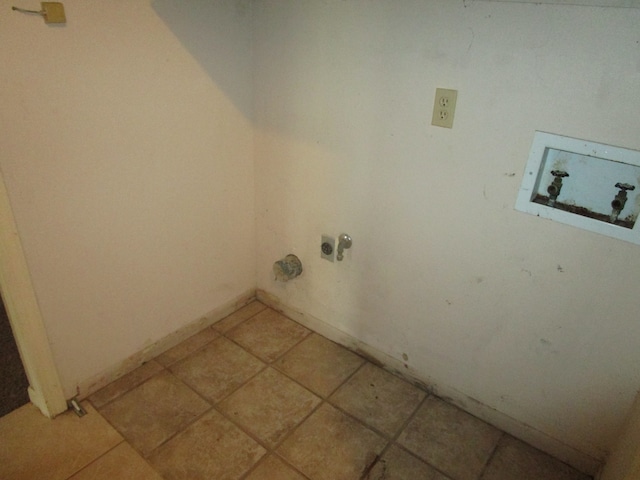 laundry area with hookup for a washing machine, light tile patterned flooring, and gas dryer hookup