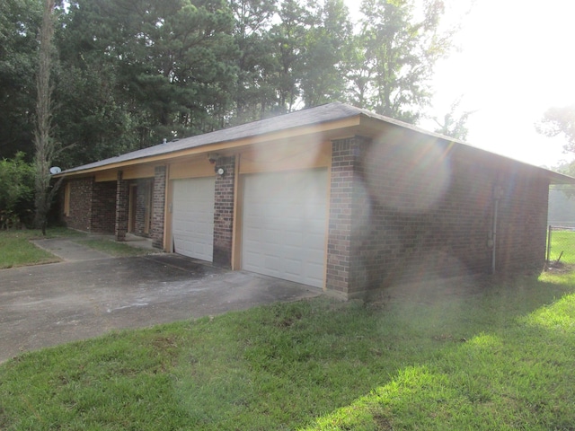 garage featuring a lawn