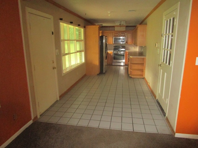 hall with crown molding and light tile patterned floors