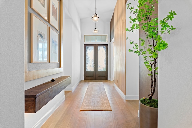 foyer with french doors and light wood-type flooring