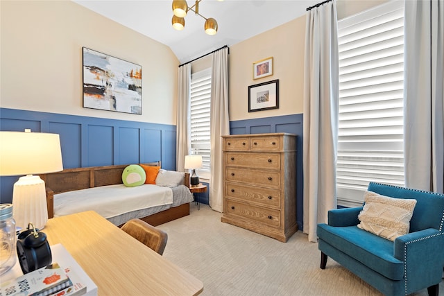 carpeted bedroom with a notable chandelier