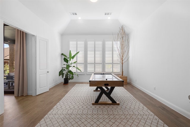 misc room with hardwood / wood-style flooring and vaulted ceiling