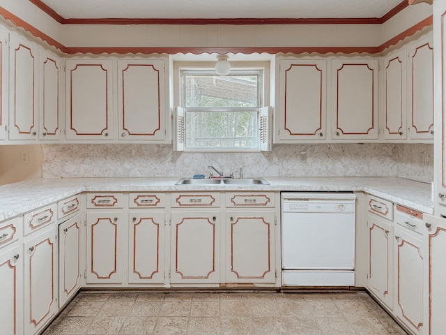 kitchen featuring ornamental molding, sink, white dishwasher, and white cabinetry