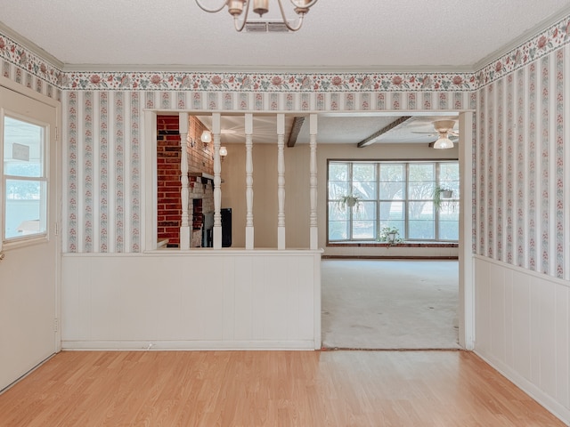 empty room with wood-type flooring and a textured ceiling